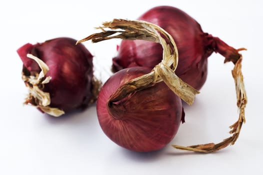 Three red onion isolated on white