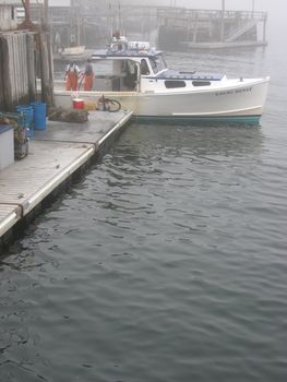 lobster boat at dock, on a foggy morning
