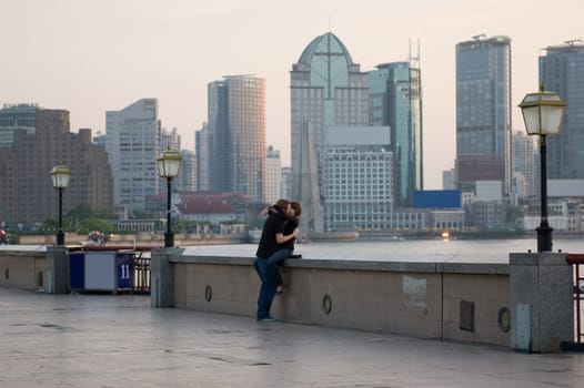 Young couple kissing at sunrise