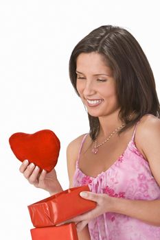 Woman taking out a plush heart from a gift box.