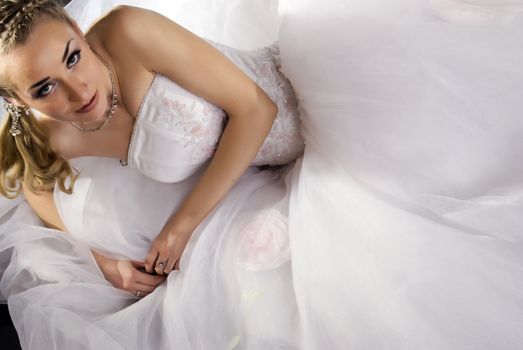 Young beautiful bride in luxuriant wedding dress 