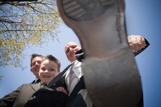 A groomsman in a wedding party decides to stomp on the photographer.  This could be used for a variety of concepts.