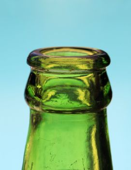 Bottle of beer against a blue background