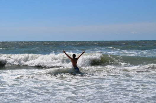 Teen watches waves