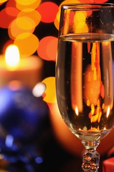 Wineglass with a champagne on a background of multicoloured sparks