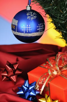 blue christmas decoration and gift on multicoloured background