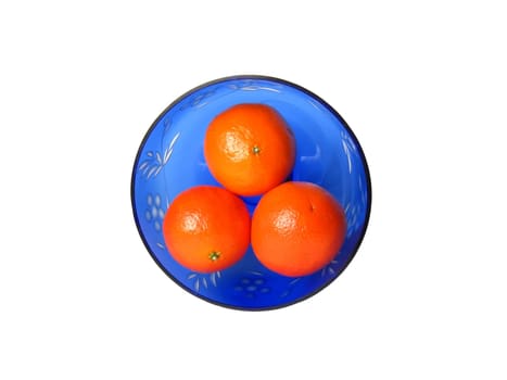 three mandarins in blue vase from top view on white background isolated 