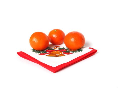 three mandarins on the napkin with christmas pattern on the white background isolated 