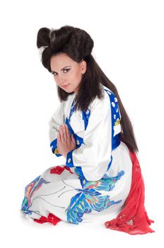 Portrait of the girl of the Asian appearance with a make-up under the geisha on a white background