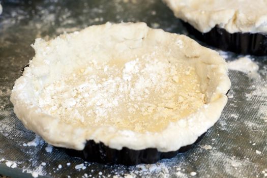 Pie crust dough in small pie or quiche pan.