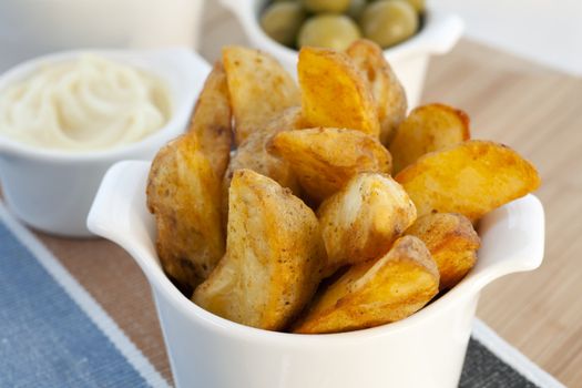 Spanish tapas, patatas bravas with garlic mayonnaise dipping sauce.