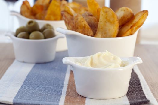Spanish tapas, patatas bravas with garlic mayonnaise dipping sauce.