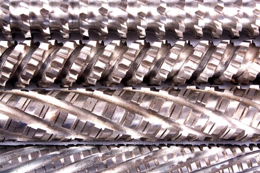 A background of a detailed view of grooves pattern in an industrial broach.