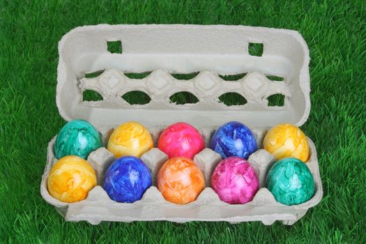 Colorful dyed easter eggs in a tray