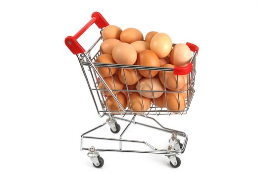 Shopping trolley filled with brown eggs on bright background