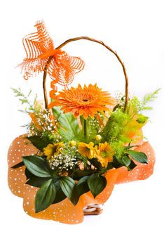 orange gerbera bouquet in basket over white