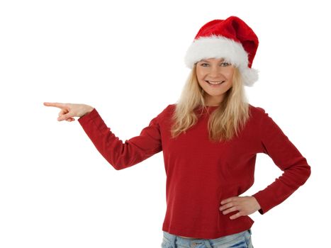 Smiling Santa girl wearing Christmas hat, showing direction. Isolated on white.