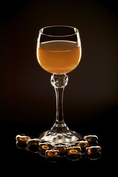 Photoillustration of a glass of amber nectar isolated on black