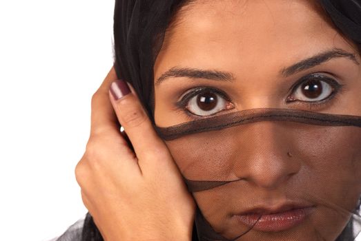 Young middle eastern woman looking at the world from behind a veil