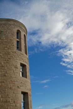 Windowed Stone tower of Port Townsend Post Office against Blue sky with clouds