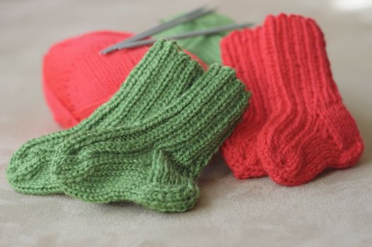 knitted baby socks in red and green