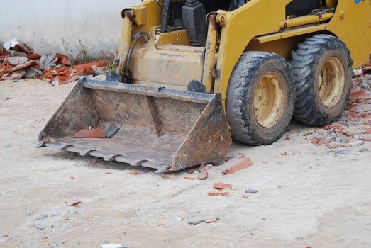 construction site with a yellow caterpillar to dig, carry and build