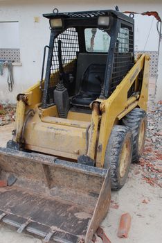 construction site with a yellow caterpillar to dig, carry and build