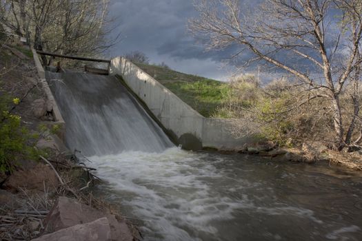 gate, footbridge and spillway of irrigation channel in Colorado farmland