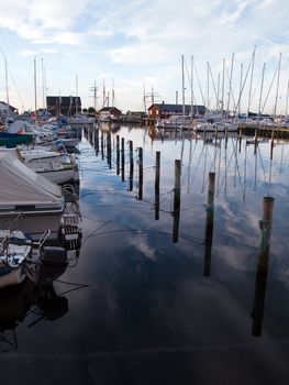 Yachts and sail boats moored to docks in a marina - sailing background vertical  image