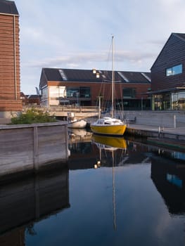 reflection of a sail boat yacht in modern marina