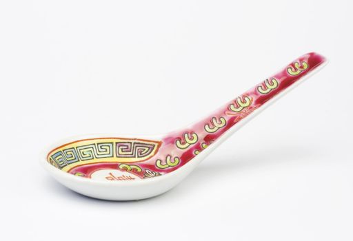 Chinese soup spoon over white background. Studio shot.