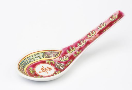 Chinese soup spoon over white background. Studio shot.