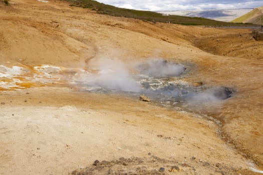 Geothermal area in Iceland. Colorful Sulphur on the ground. Summer day.