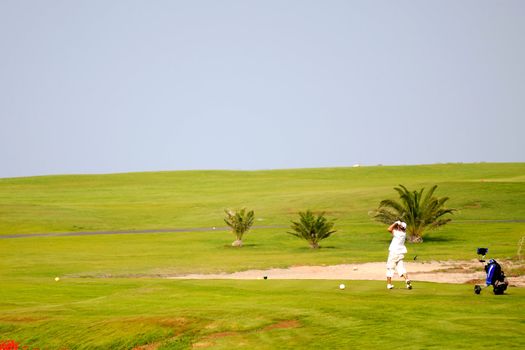 Man playing golf at exotic course