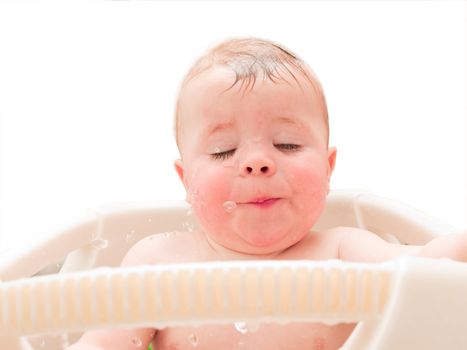 Happy baby boy enjoying water in his bath