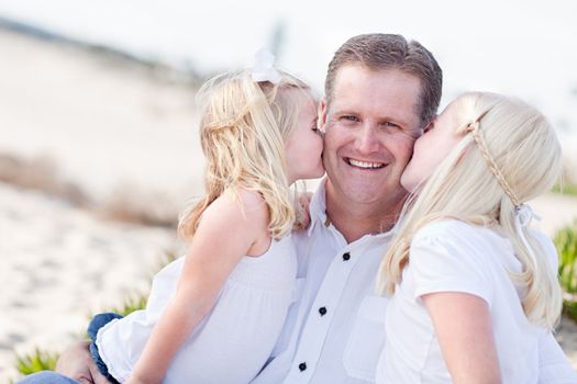 Handsome Dad Getting Kisses from His Cute Daughters at The Beach.