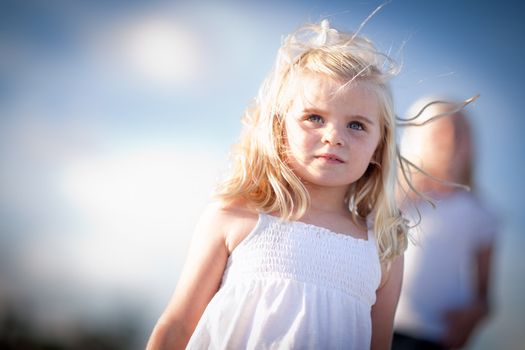 Adorable Blue Eyed Girl Playing Outside with Her Family.