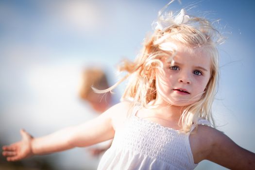 Adorable Blue Eyed Girl Playing Outside with Her Family.