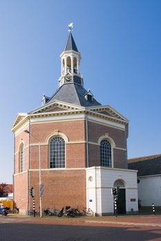 Dutch village church in the morning sun with blue sky