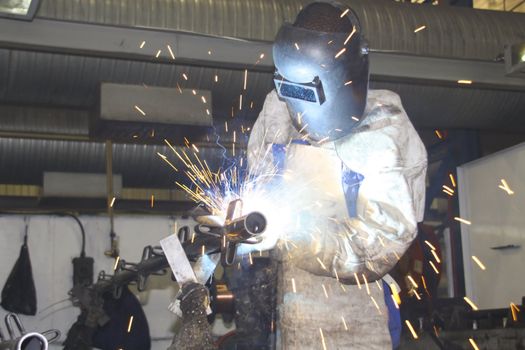 Man welding on a production line