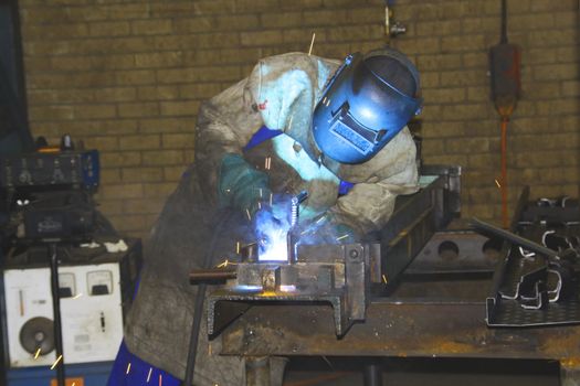 Man arc welding a sheet of metal