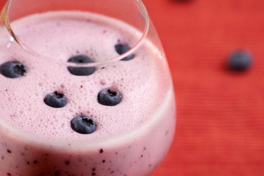 A delicious blueberry smoothie over a red cloth background