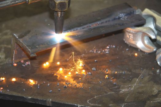 Acetylene torch throwing sparks as it cuts through a metal cornice