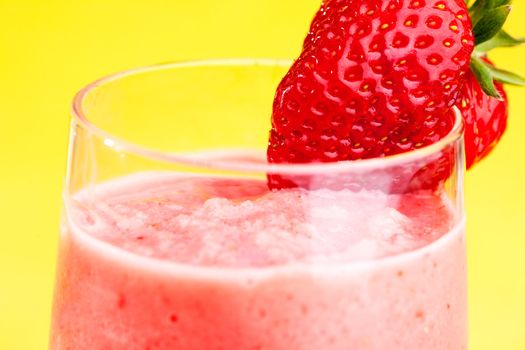 A fresh strawberry smoothie isolated over yellow