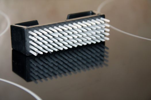 nailbrush / scrubbing brush isolated on a reflective black surface