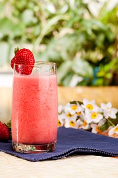 A fresh summer strawberry drink in an outdoor setting