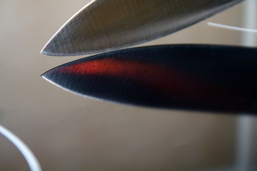 Knife blade on a reflective black surface