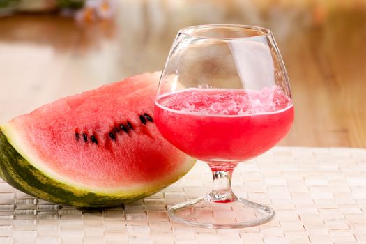 A red watermelon drink on a picnic table