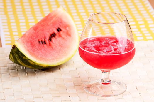 A red watermelon drink on a picnic table