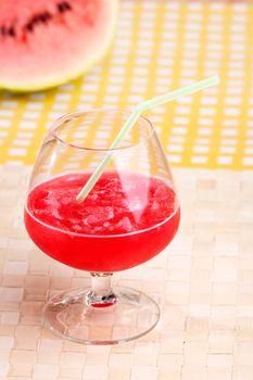 A red watermelon drink on a picnic table